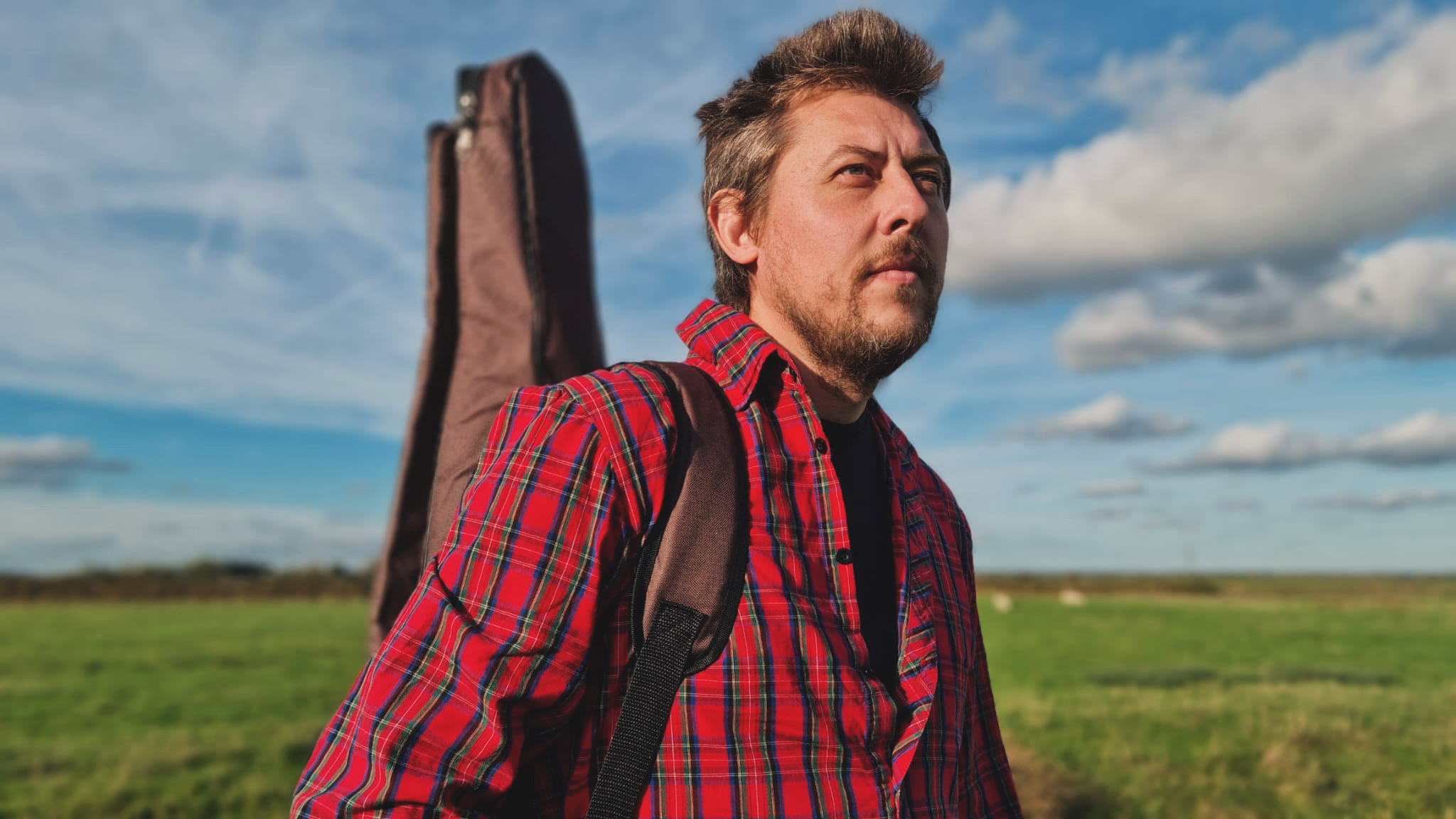 Donny Utton Singer Songwriter standing in a field