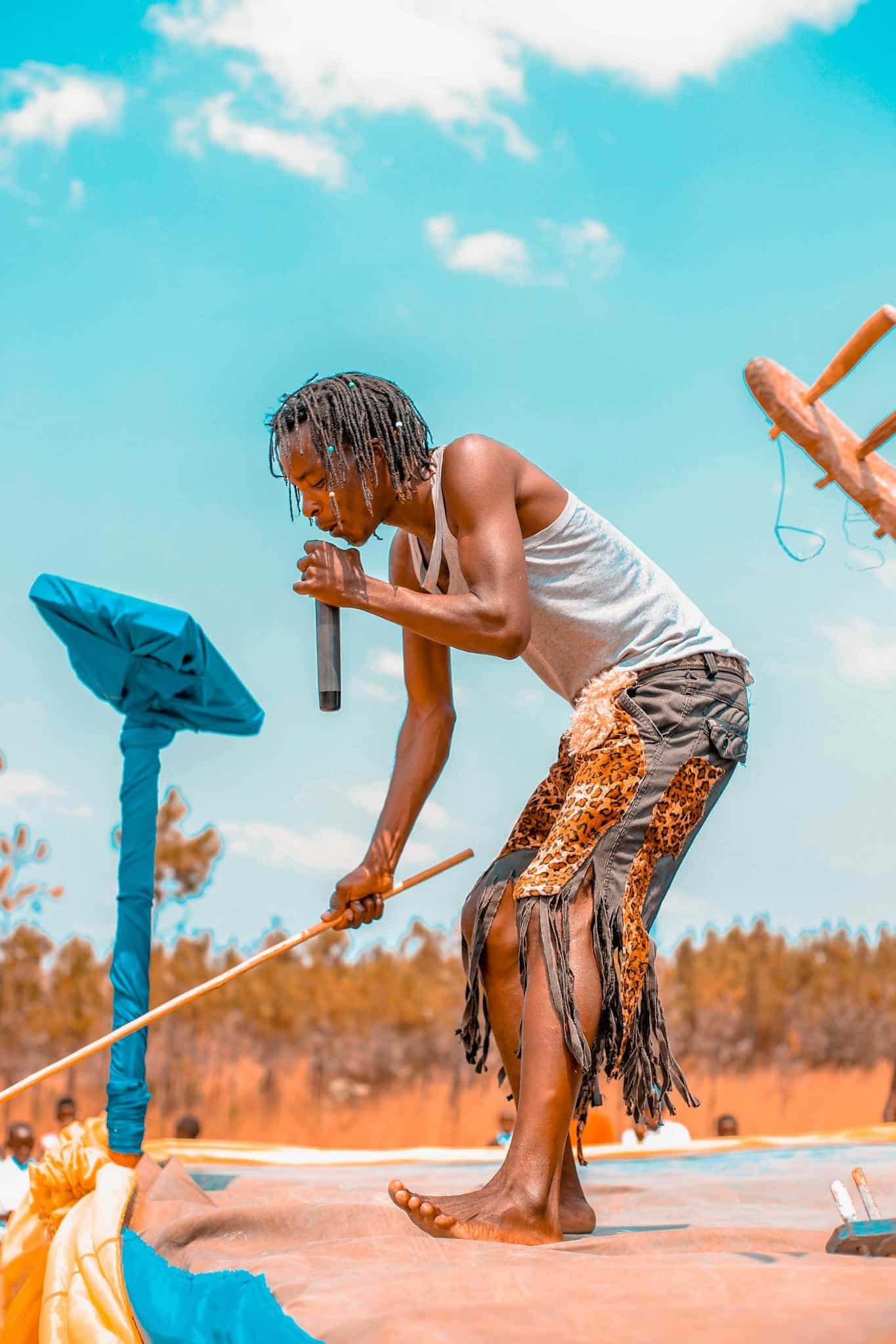 Energetic live performance by a young musician in Mbeya Region, Tanzania under clear skies.